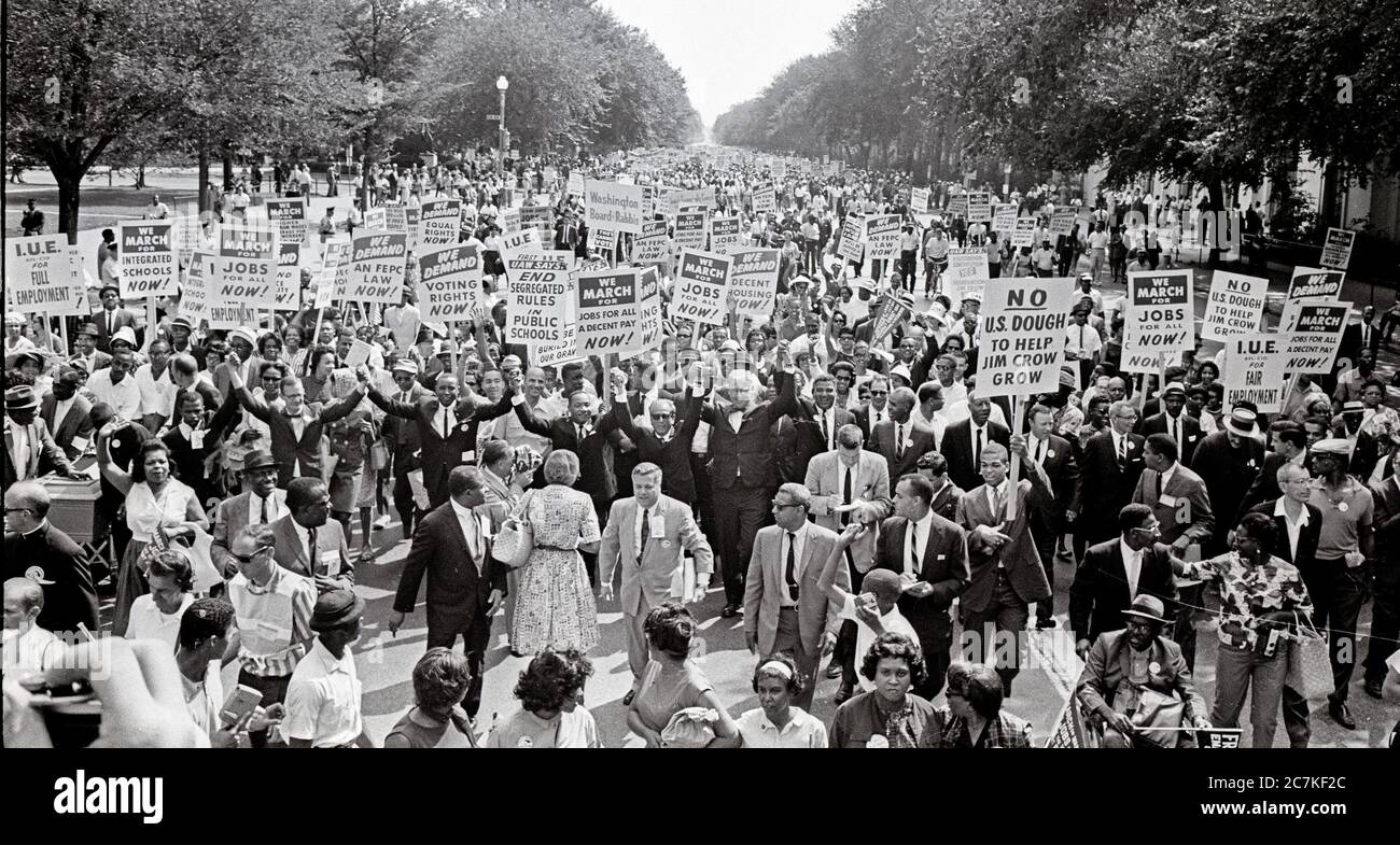 Leaders of the 1963 March on Washington for Jobs and Freedom raise their hands together as they move along Constitution Avenue in Washington, DC on August 28, 1963. Some of the leaders in the march, from left to right, include John Lewis, Mathew Ahmann, Roy Wilkins, Dr. King, Rabbi Joachim Prinz, A. Philip Randolph, and Whitney Young. Credit: Arnie Sachs/CNP | usage worldwide Stock Photo