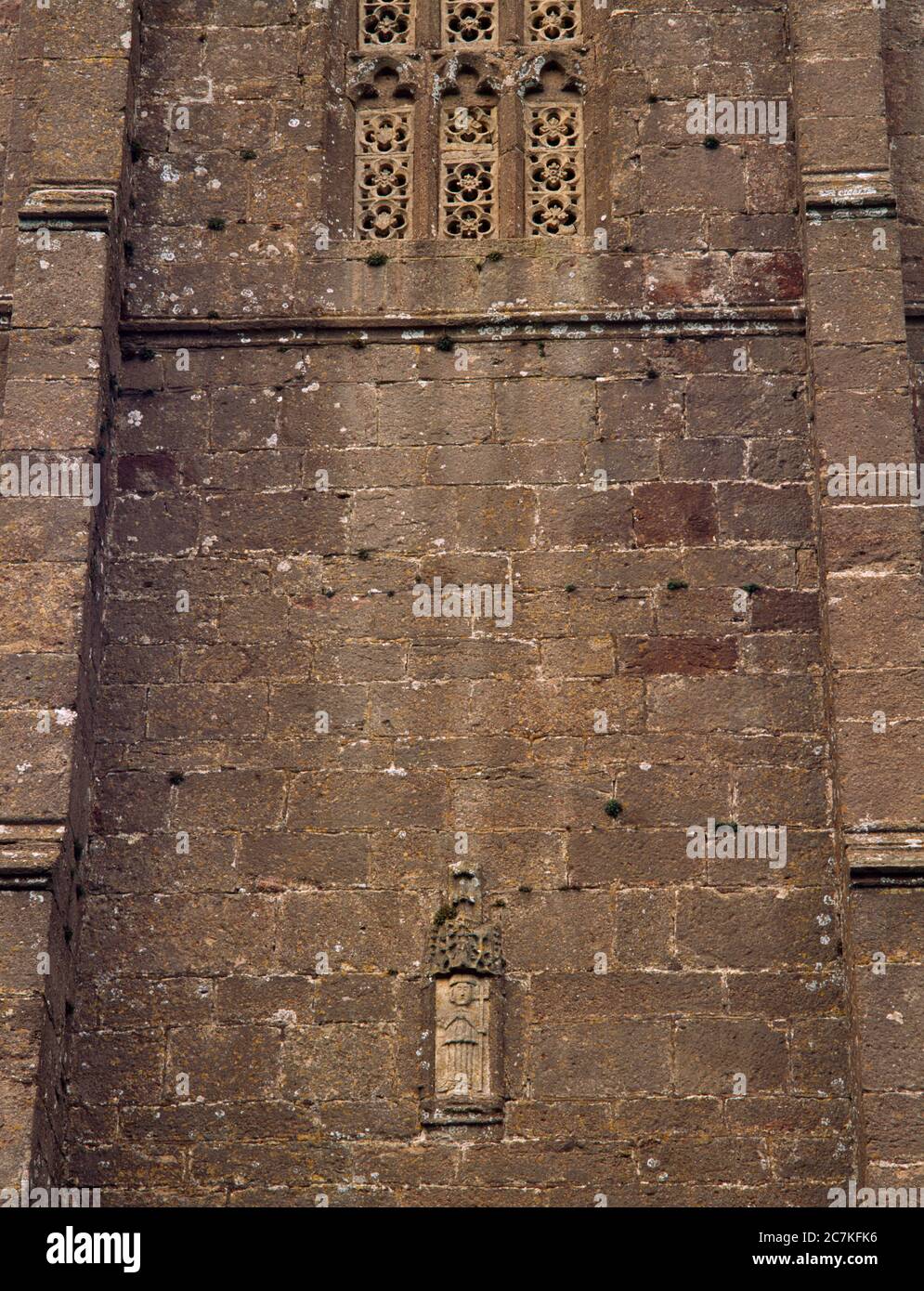 Traceried bell-openings & a statue of St Decuman holding a cross on the S side of the Perpendicular W tower of St Decuman's Church, Watchet, Somerset. Stock Photo