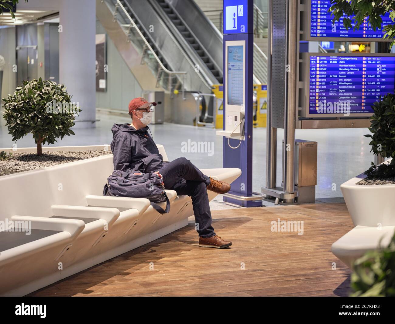 A traveler with a face mask in the waiting area of Terminal 1 at Frankfurt Airport during the