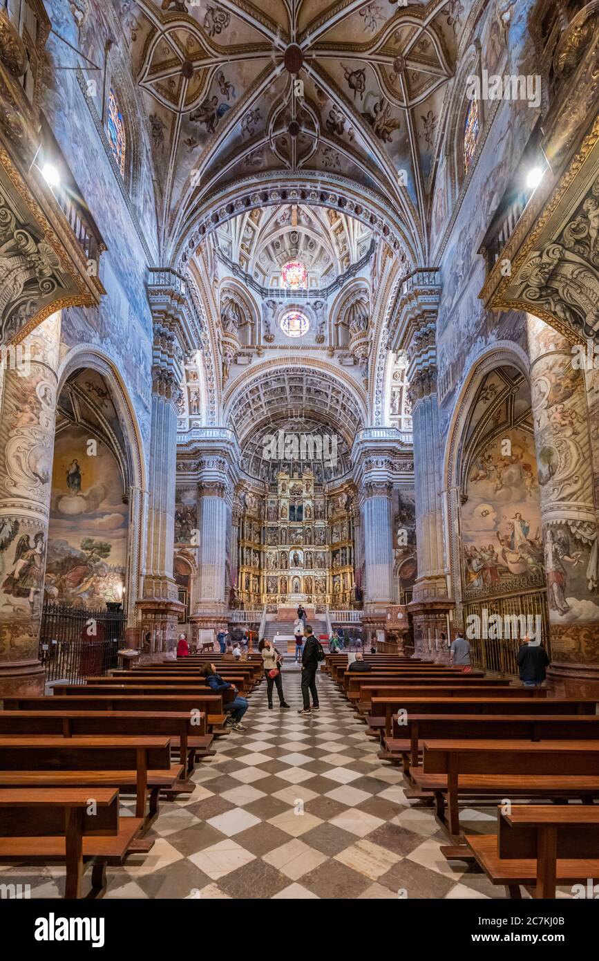 Frescos cover the walls and columns of the Spanish Renaissance nave and high altar in the main chapel of Real Monasterio de San Jeronimo de Granada Stock Photo