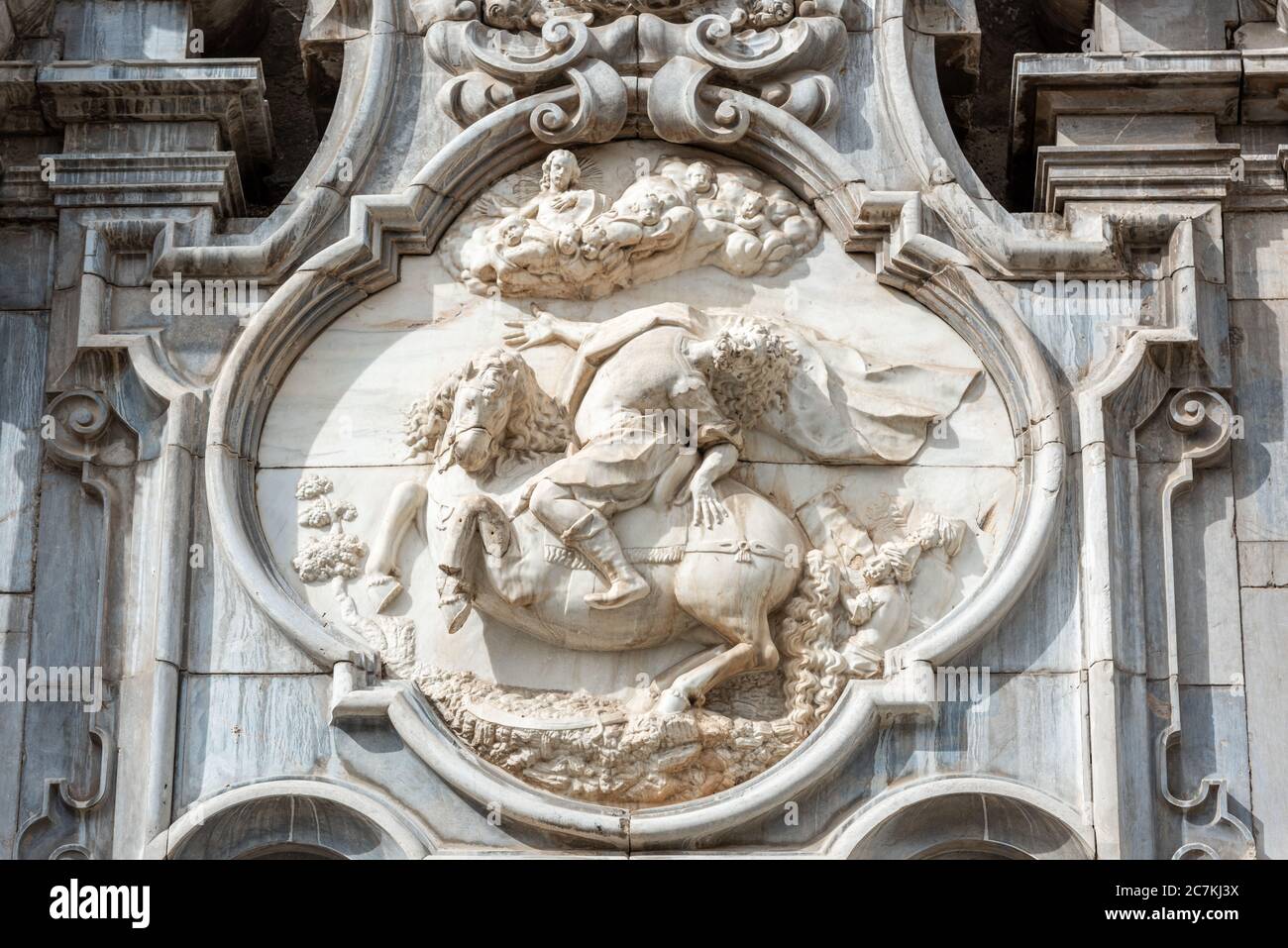 An equestrian relief above the entrance to the 16th century Iglesia de San Justo y Pastor in Granada depicts the conversion of Saint Paul. Stock Photo