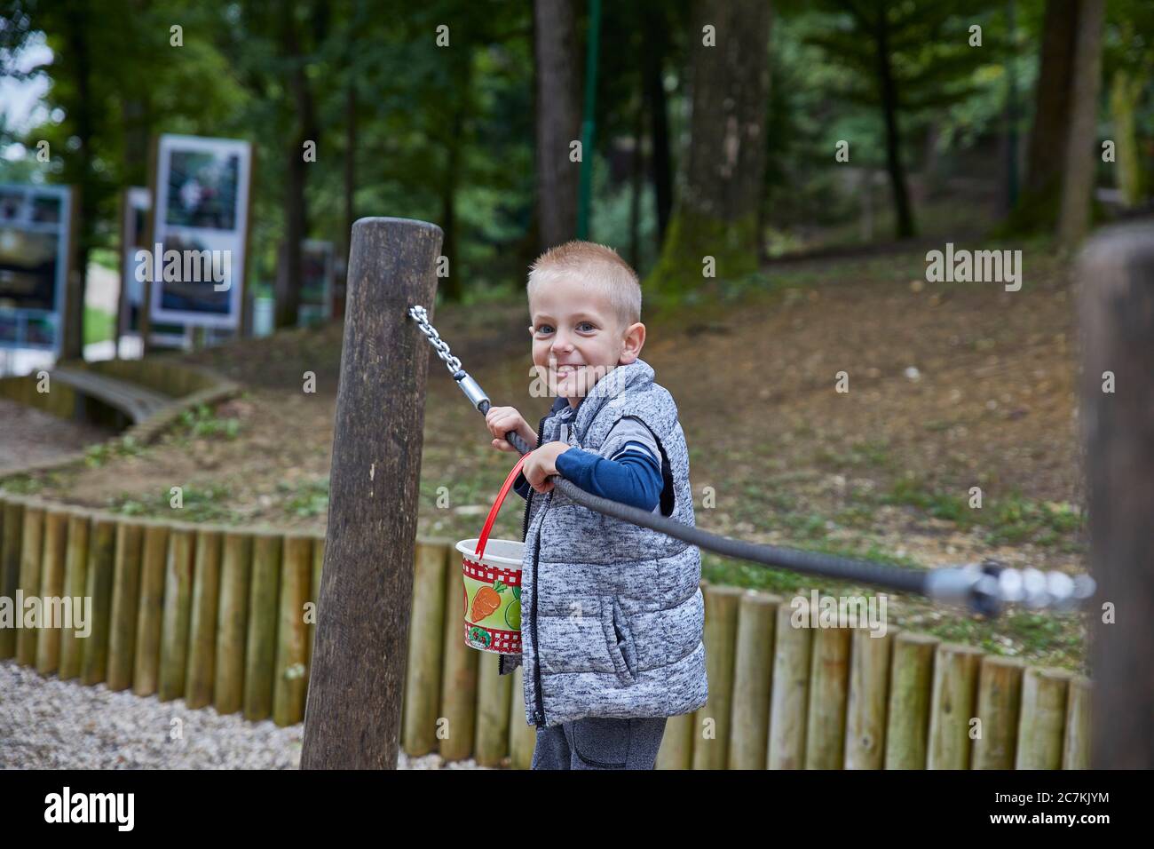 Little boy playing on the horizontal bars in the playground Stock Photo