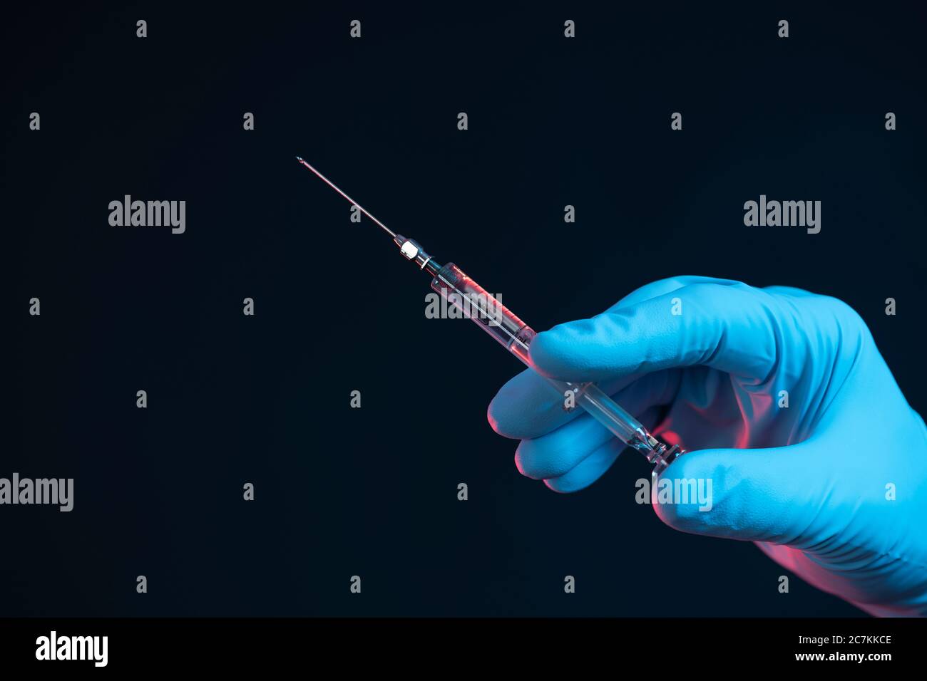Symbol, corona, science, research, vaccine, danger, right, syringe, cannula, hand, bottom right Stock Photo