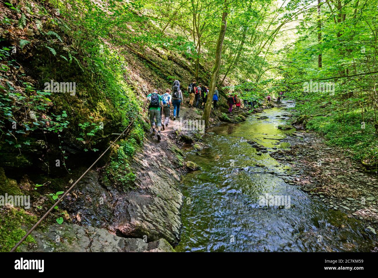At the narrowest point in the Ehrbachklamm, hikers shimmy along wire ...