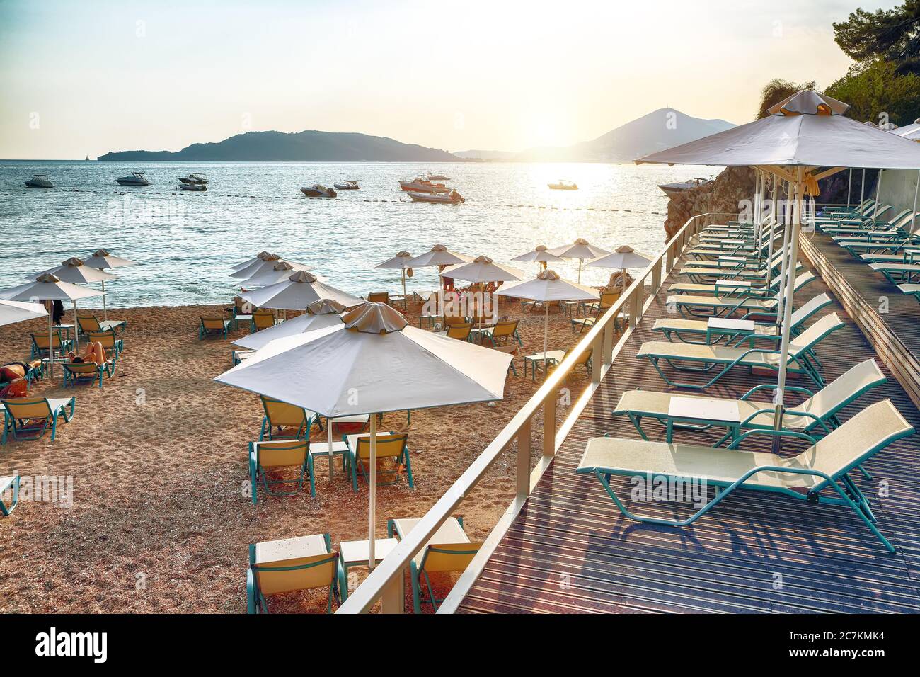 Picturesque summer view of Adriatic sea coast in Budva Riviera near Przno village. Cozy beach with umbrellas. Location: Przno village, Montenegro, Bal Stock Photo