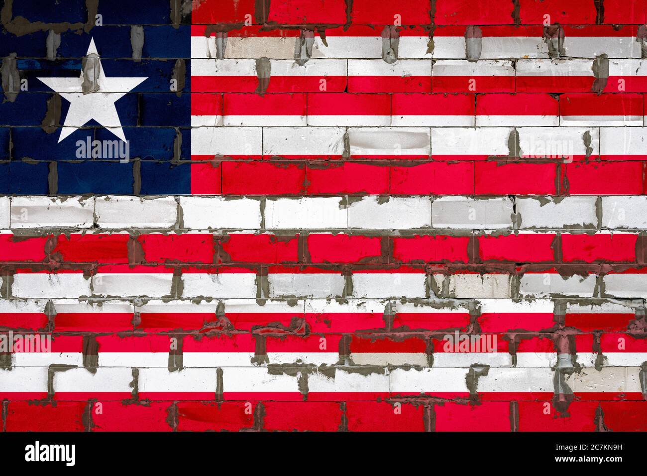 The national flag of Liberia painted on a wall of sibit blocks with ...