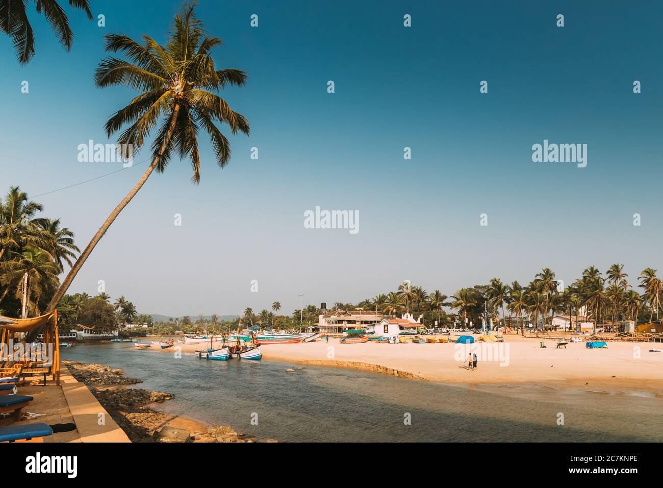 Mapusa, Goa, India. Fishermen Resting Near Pulled Boat From Sea Stock Photo