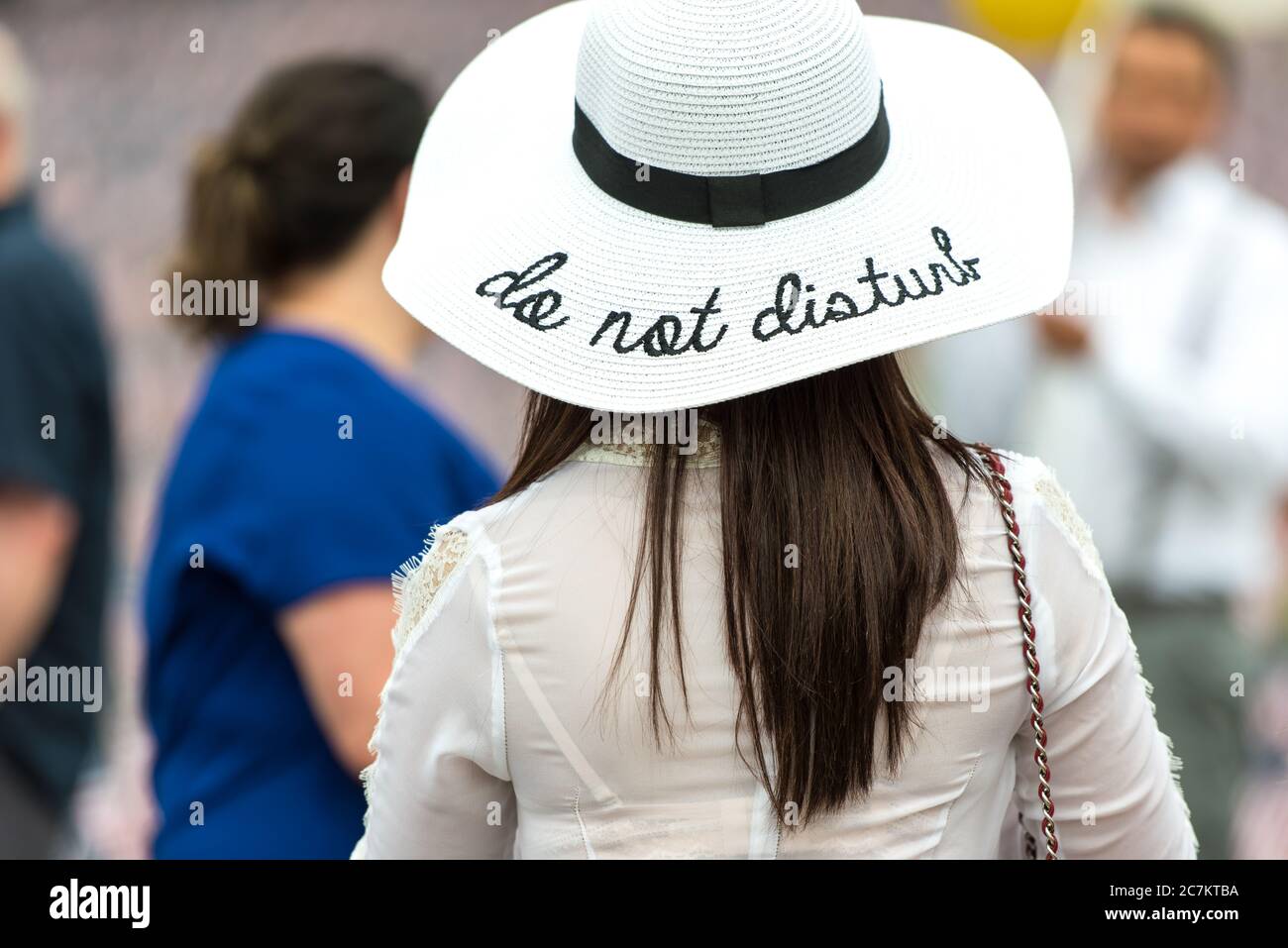 Woman wearing a white sun hat with the 