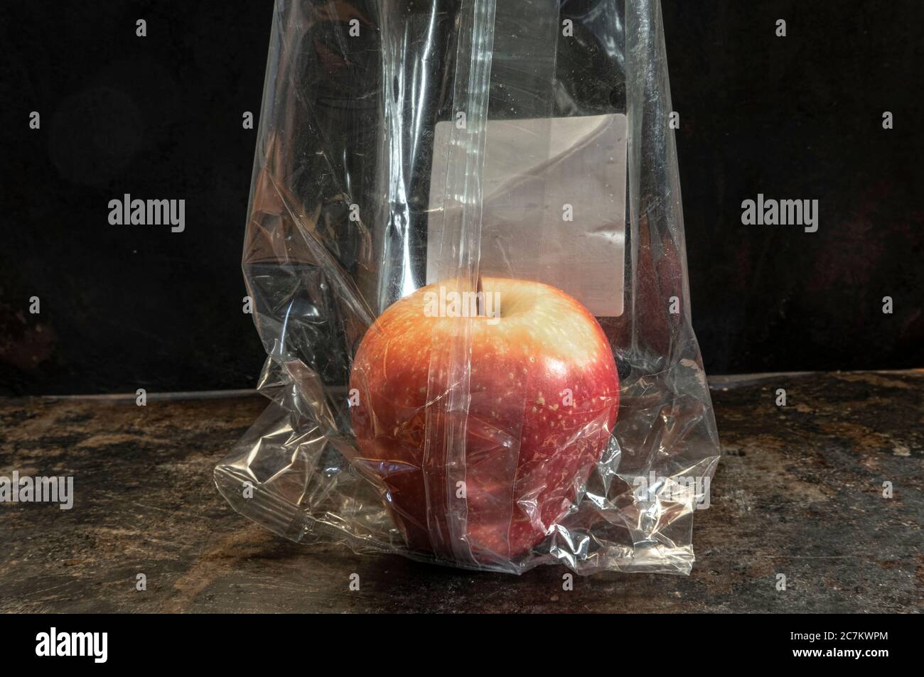 apple packed in non-biodegradable plastics Stock Photo