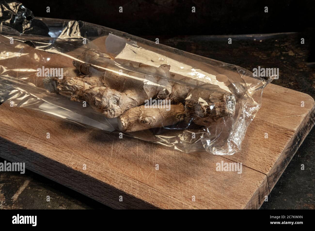 cut ginger on a dark background Stock Photo