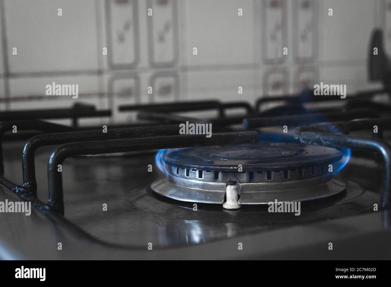 Closeup shot of a lit stove burner with blue flames Stock Photo Alamy