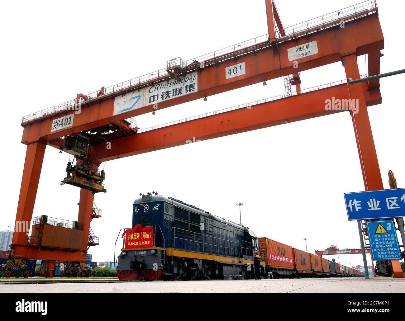 Zhengzhou, China's Henan Province. 18th July, 2020. A China-Europe freight train waits for departure at a station in Zhengzhou, capital of central China's Henan Province, July 18, 2020. Zhengzhou has seen the operation of 3,274 China-Europe cargo trains in the past seven years, with goods in cumulative value of more than 13.88 billion U.S. dollars. Launched in July 2013, the logistic network of China-Europe freight train services originating from Zhengzhou has covered 130 cities in 30 countries. Credit: Li An/Xinhua/Alamy Live News Stock Photo