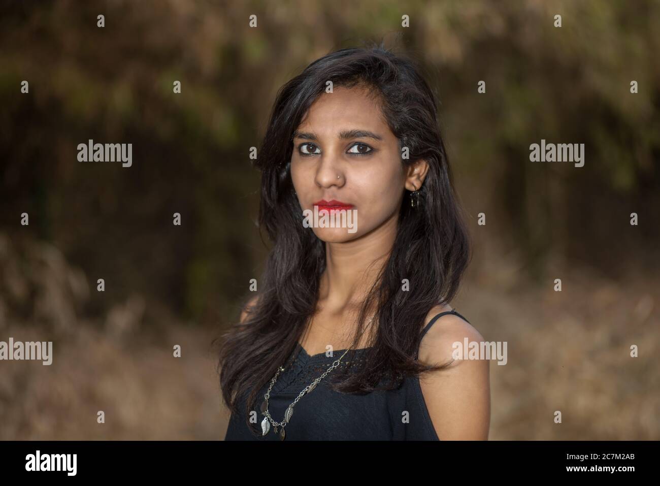 Beautiful young girl posing in a park, Portrait Stock Photo - Alamy