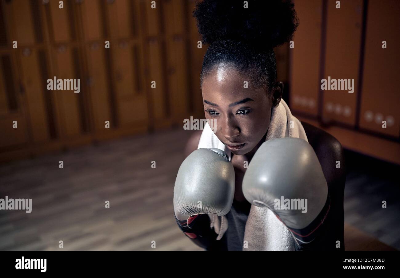 Boxing woman exercise at training Young woman boxer wearing gloves