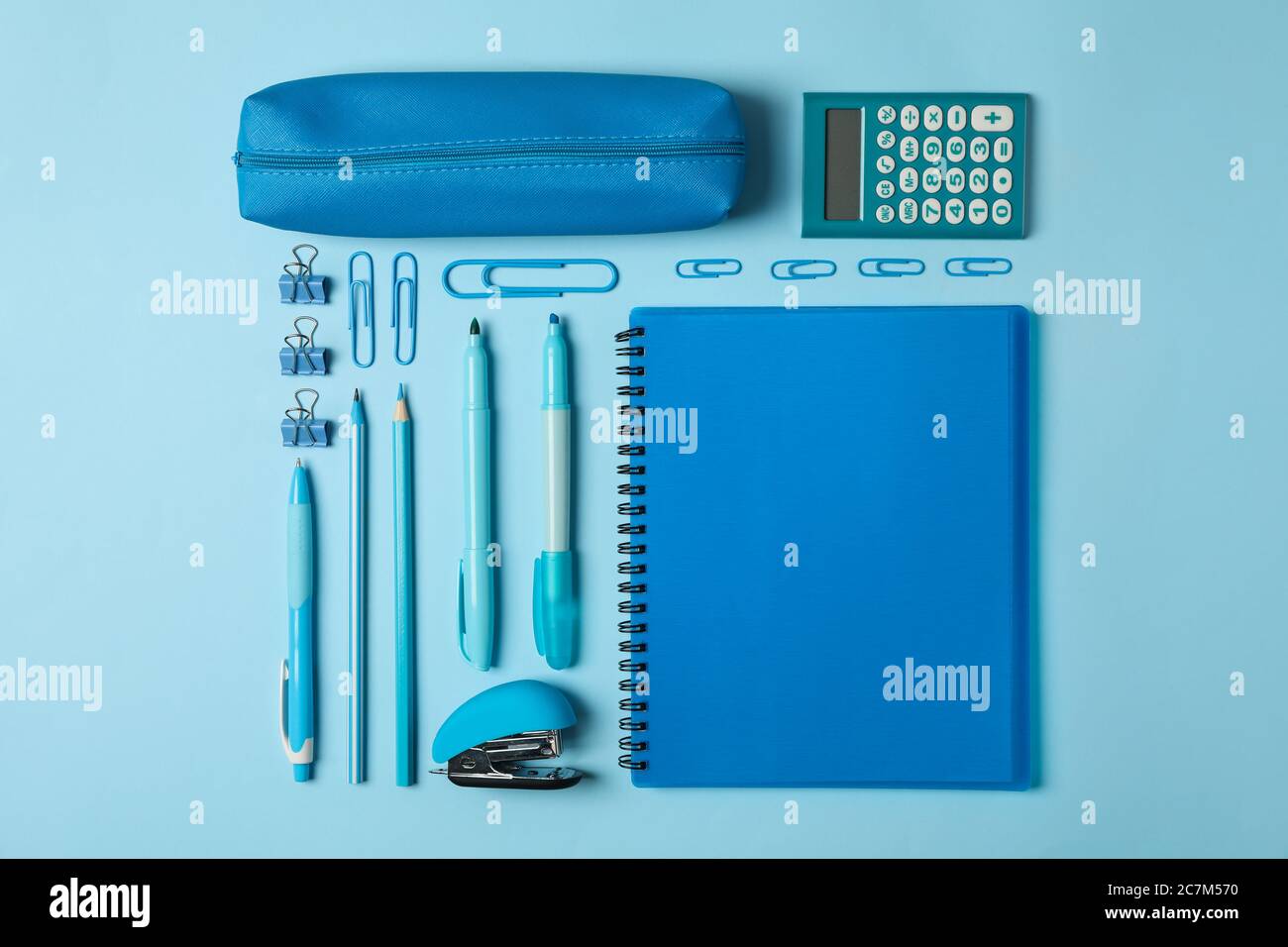 Flat lay with different school supplies on blue background Stock Photo
