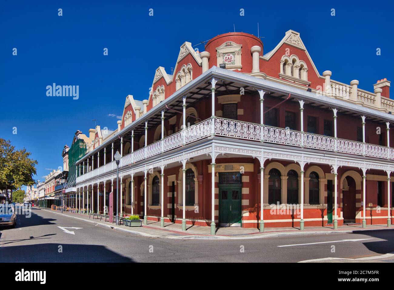 Typical older style buildings with arches and verandas with pretty wrought iron railings on a street in Fremantle, Western Australia. Stock Photo