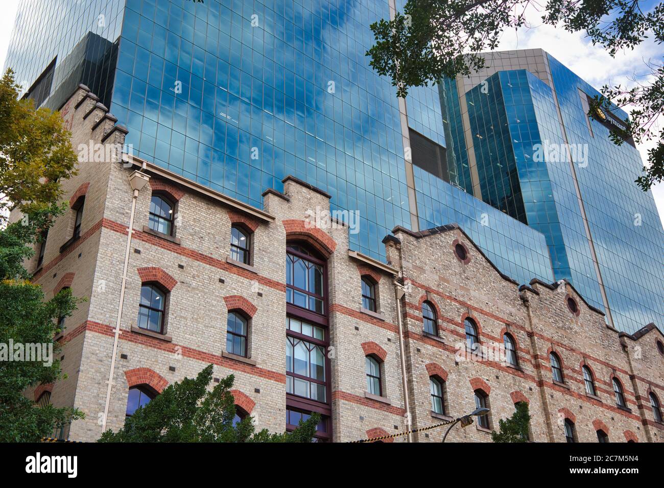 Buildings old and new in the Rocks area of Sydney, glass fronted high riser behind an early 1900s facade, in Sydney, New South Wales, Australia Stock Photo