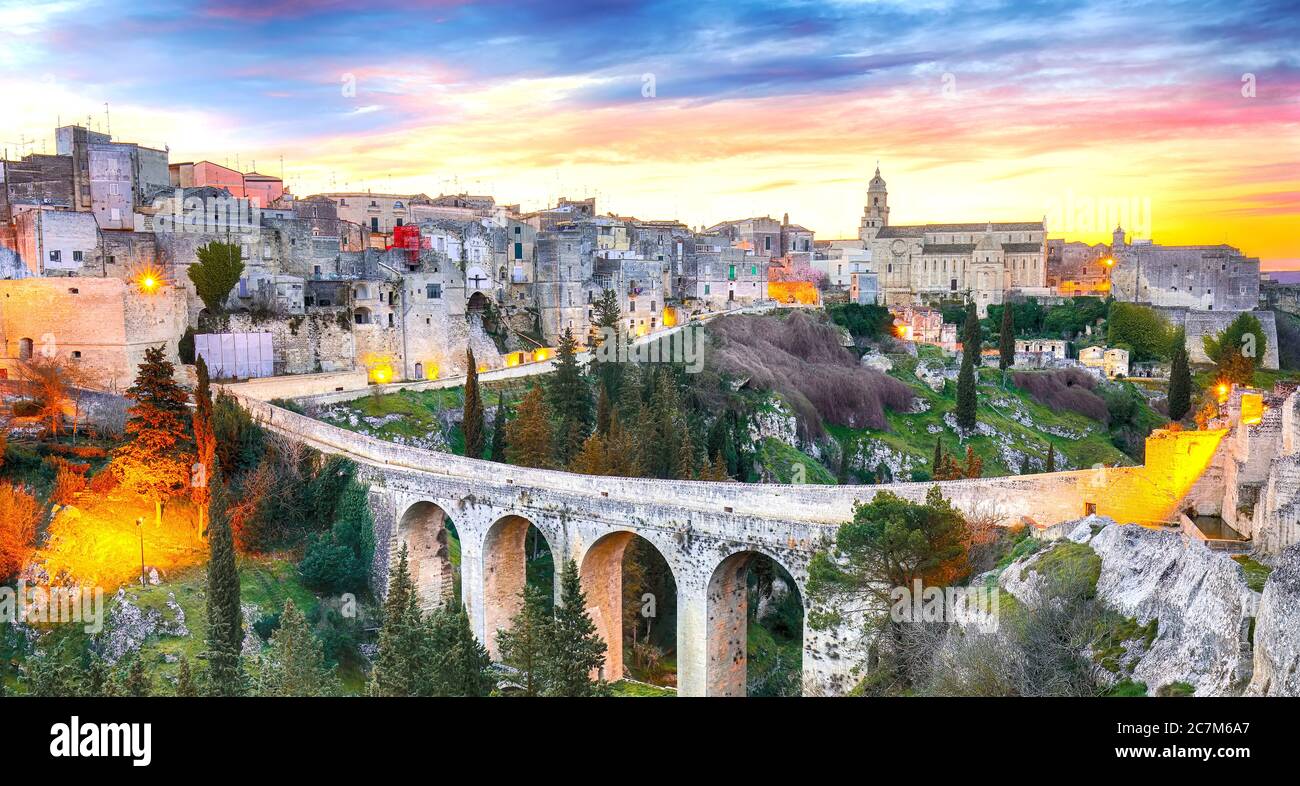 Gravina in Puglia ancient town, bridge and canyon at sunrise. Panoramic view of old city Gravina in Puglia, Apulia, Italy. Europe Stock Photo