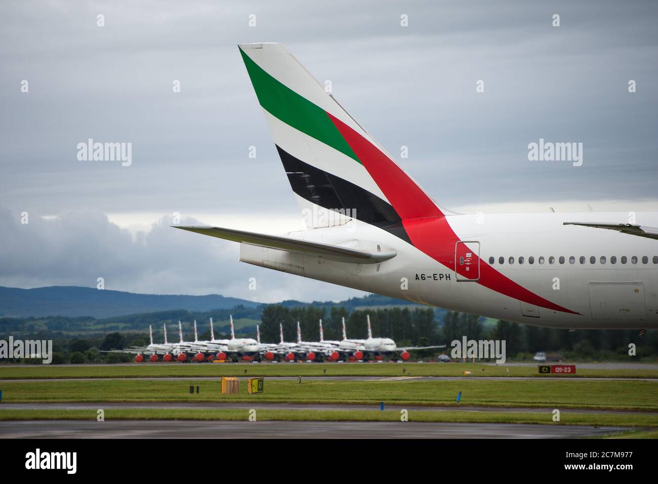 Glasgow, Scotland, UK. 17 July 2020. Pictured:  Second day back of Emirates flights back into Glasgow after the eaed coronavirus lockdown seen against a backdrop of grounded British Airways Airbus A319/A320/A321 aircraft, showing how bad the coronavirus (COVID19) crisis has affected the global airline industry. British Airways today axed all of its Boeing 747 services cutting back and have already axed a quarter of its staff due to the pandemic, however Emirates Airlines have said they are opening back up more routes. Credit: Colin Fisher/Alamy Live News. Stock Photo