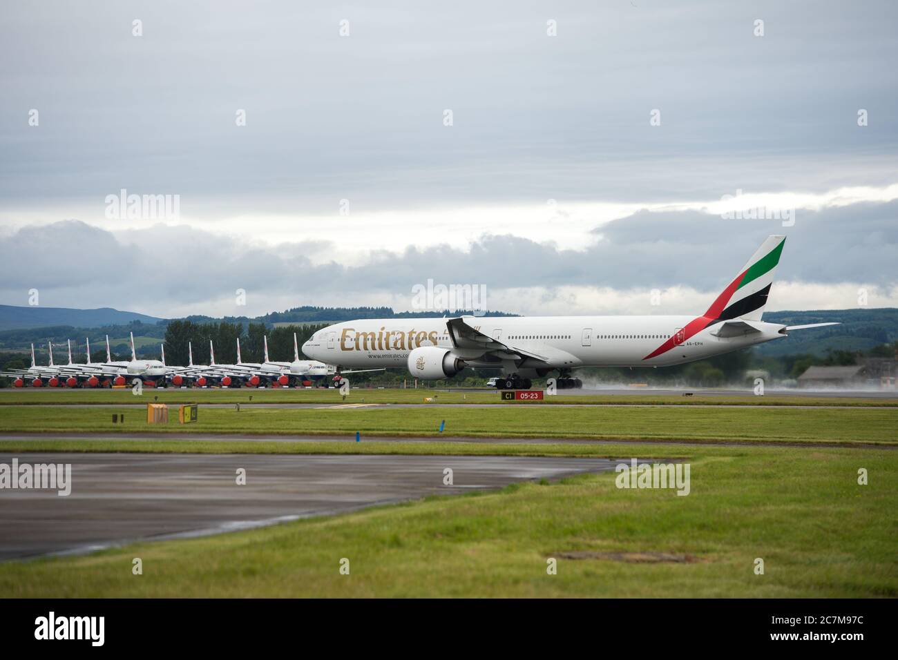 Glasgow, Scotland, UK. 17 July 2020. Pictured:  Second day back of Emirates flights back into Glasgow after the eaed coronavirus lockdown seen against a backdrop of grounded British Airways Airbus A319/A320/A321 aircraft, showing how bad the coronavirus (COVID19) crisis has affected the global airline industry. British Airways today axed all of its Boeing 747 services cutting back and have already axed a quarter of its staff due to the pandemic, however Emirates Airlines have said they are opening back up more routes. Credit: Colin Fisher/Alamy Live News. Stock Photo