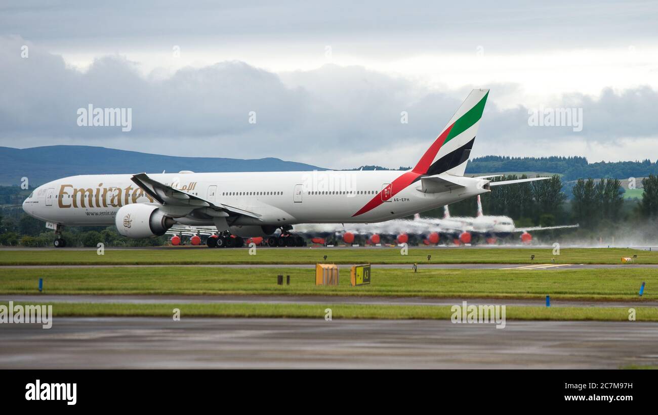 Glasgow, Scotland, UK. 17 July 2020. Pictured:  Second day back of Emirates flights back into Glasgow after the eaed coronavirus lockdown seen against a backdrop of grounded British Airways Airbus A319/A320/A321 aircraft, showing how bad the coronavirus (COVID19) crisis has affected the global airline industry. British Airways today axed all of its Boeing 747 services cutting back and have already axed a quarter of its staff due to the pandemic, however Emirates Airlines have said they are opening back up more routes. Credit: Colin Fisher/Alamy Live News. Stock Photo