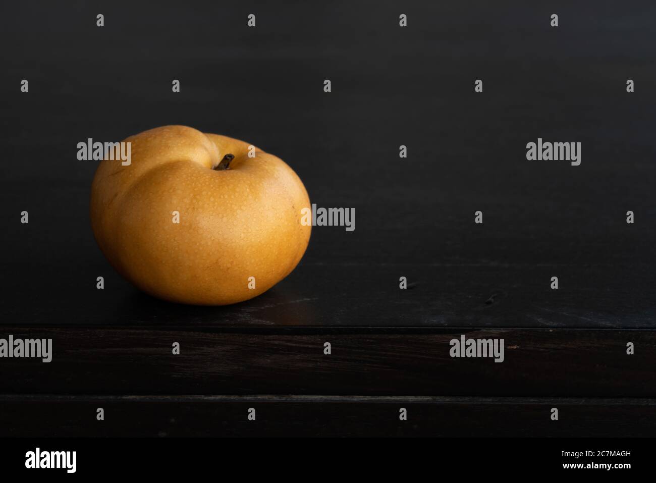 Closeup shot of a fresh man shui pear on a dark surface - perfect for wallpapers Stock Photo