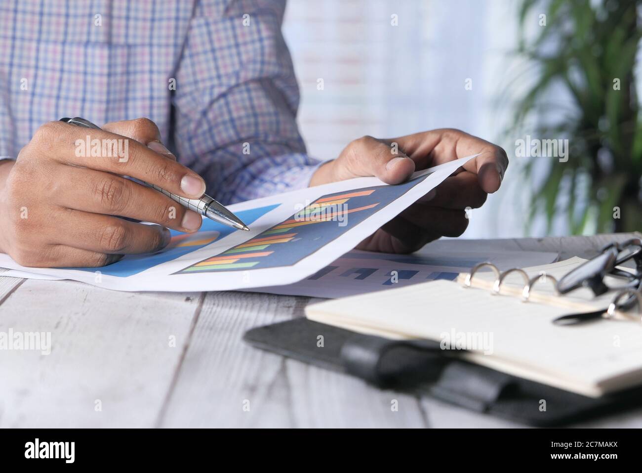 man hand with pen analyzing bar chart on paper on office desk Stock ...