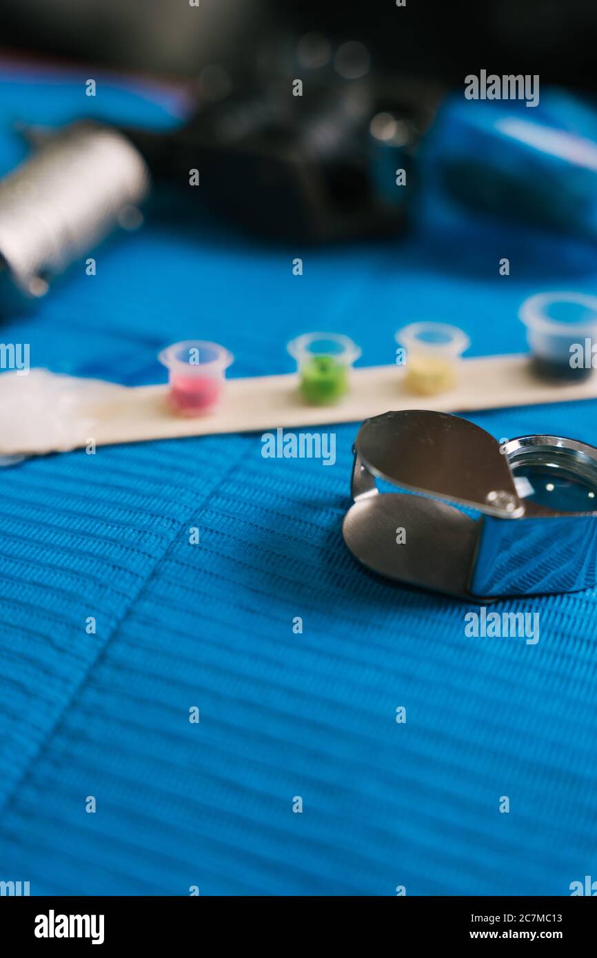 Vertical shot of tattooing tools on a blue surface Stock Photo