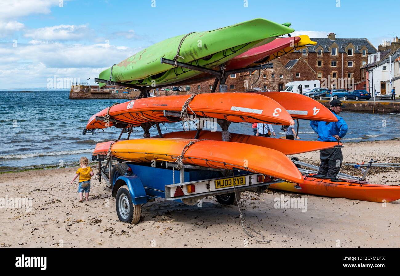 North Berwick, East Lothian, Scotland, United Kingdom, 18th July 2020. UK Weather: Summer sunshine in the seaside town. A trailer on the beach with a stack of sea kayaks Stock Photo