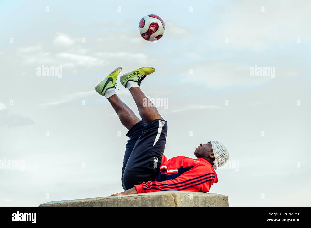 PARIS, FRANCE - Jul 13, 2019: A series of images showing a young man performing a show with his football in front of the Sacre Coeur Church in Montmar Stock Photo