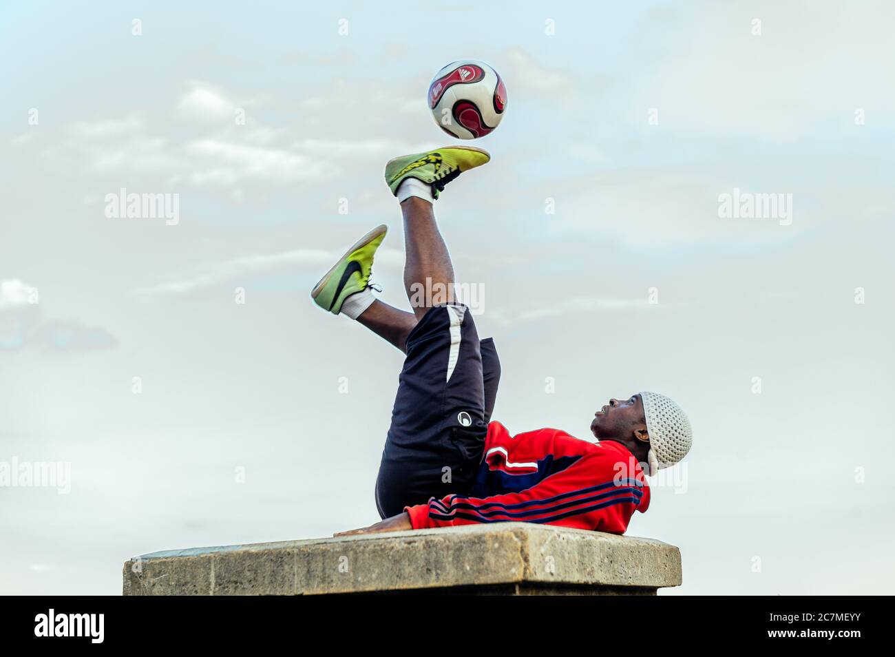 PARIS, FRANCE - Jul 13, 2019: A series of images showing a young man performing a show with his football in front of the Sacre Coeur Church in Montmar Stock Photo