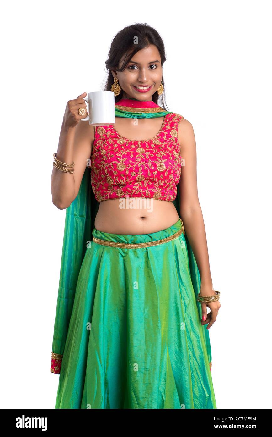 Beautiful young girl with cup of tea or coffee posing on white ...
