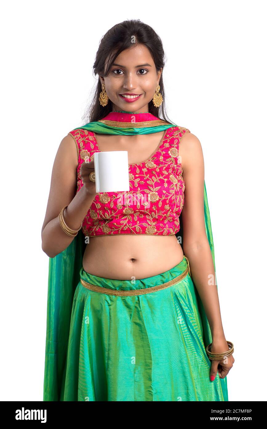 Beautiful young girl with cup of tea or coffee posing on white ...