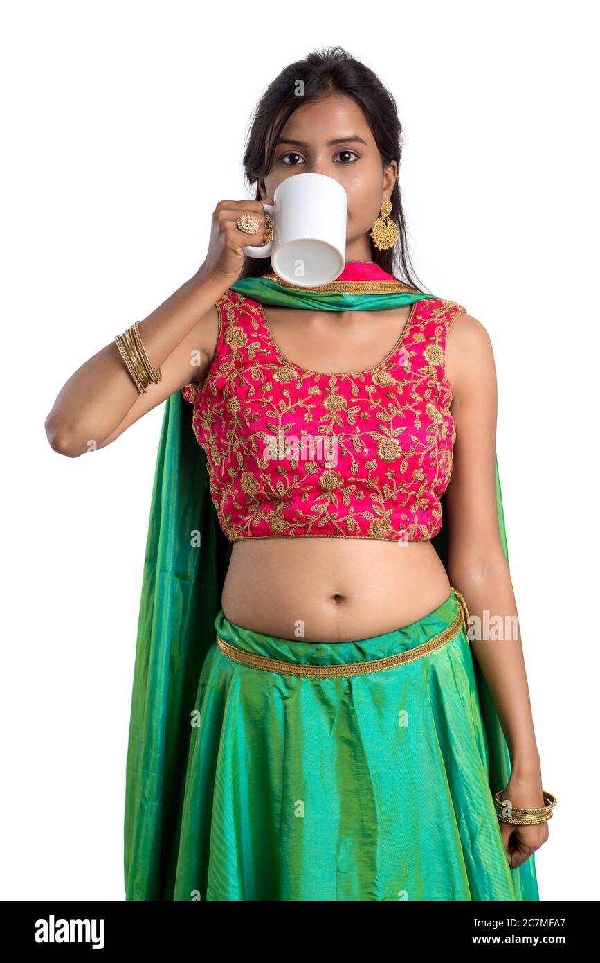 Beautiful young girl with cup of tea or coffee posing on white ...