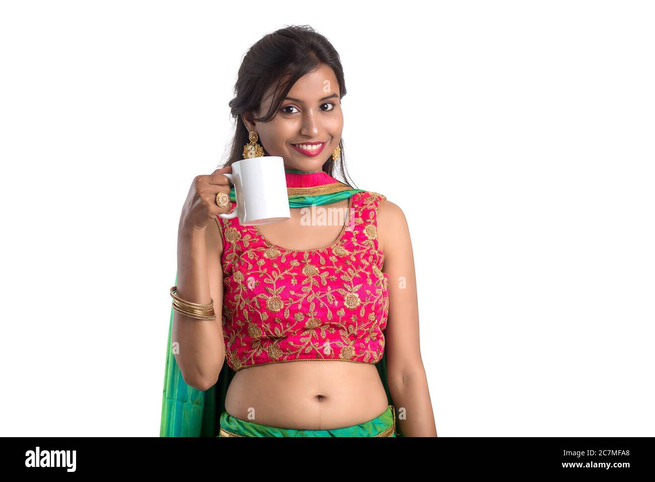 Beautiful young girl with cup of tea or coffee posing on white ...