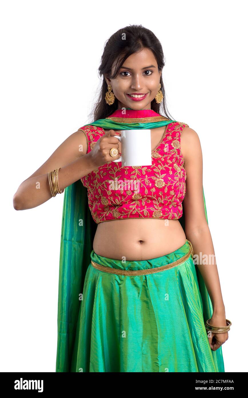 Beautiful young girl with cup of tea or coffee posing on white ...