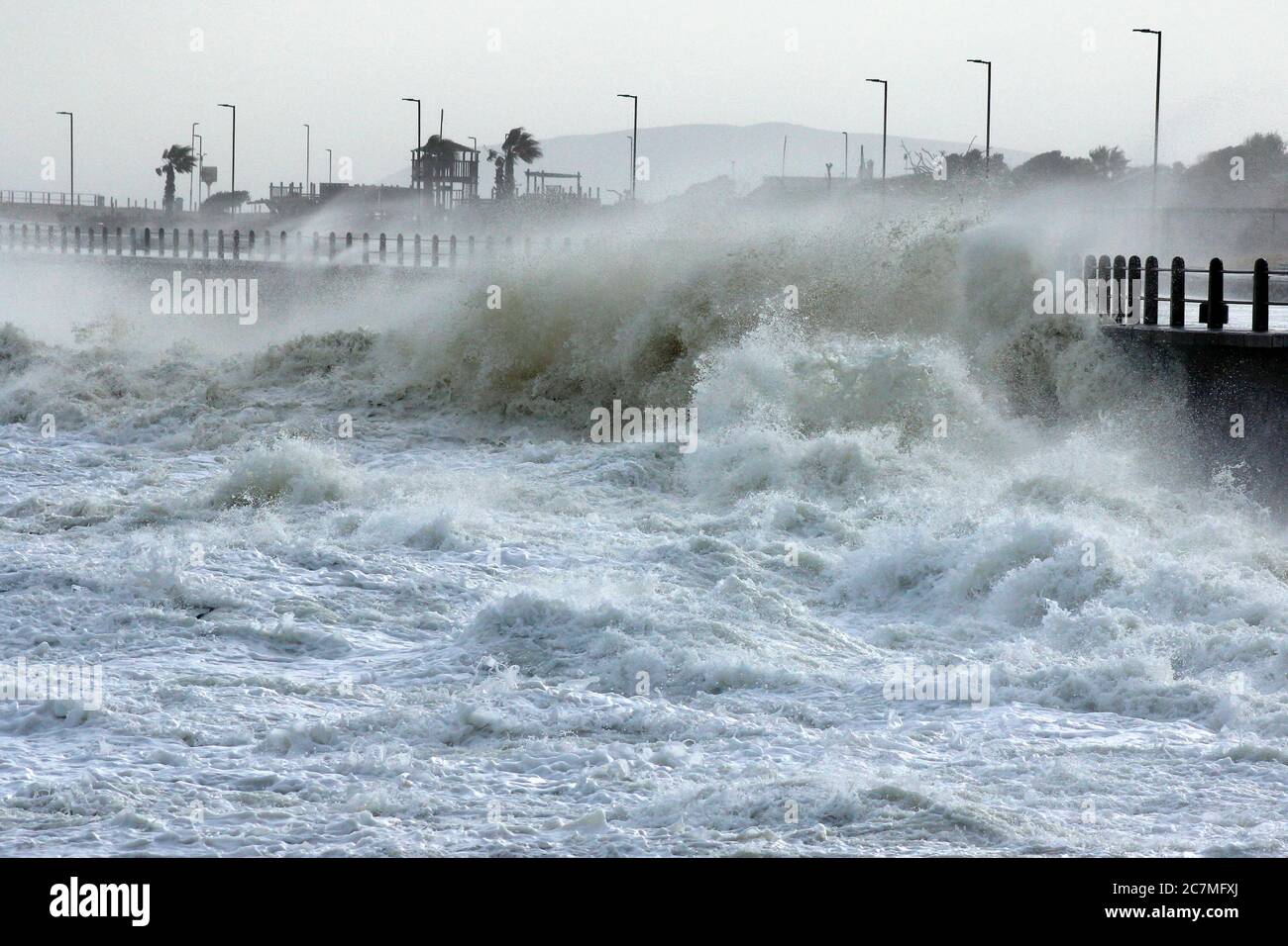 Massive storm waves battering the seawall in Cape Town during an intense winter storm. Stock Photo