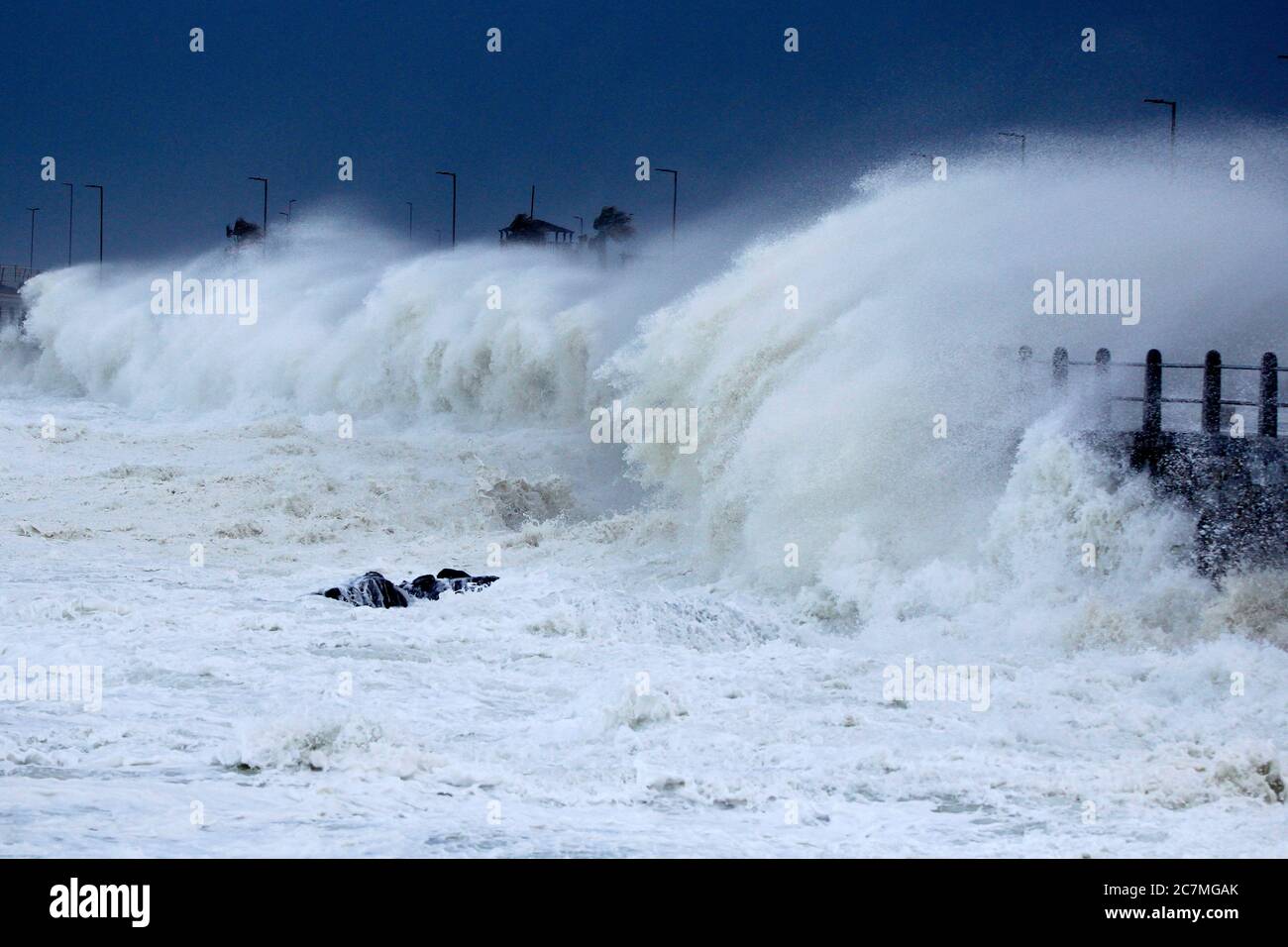 Huge storm waves being blown over the seawall in Cape Town during an intense winter storm. Stock Photo