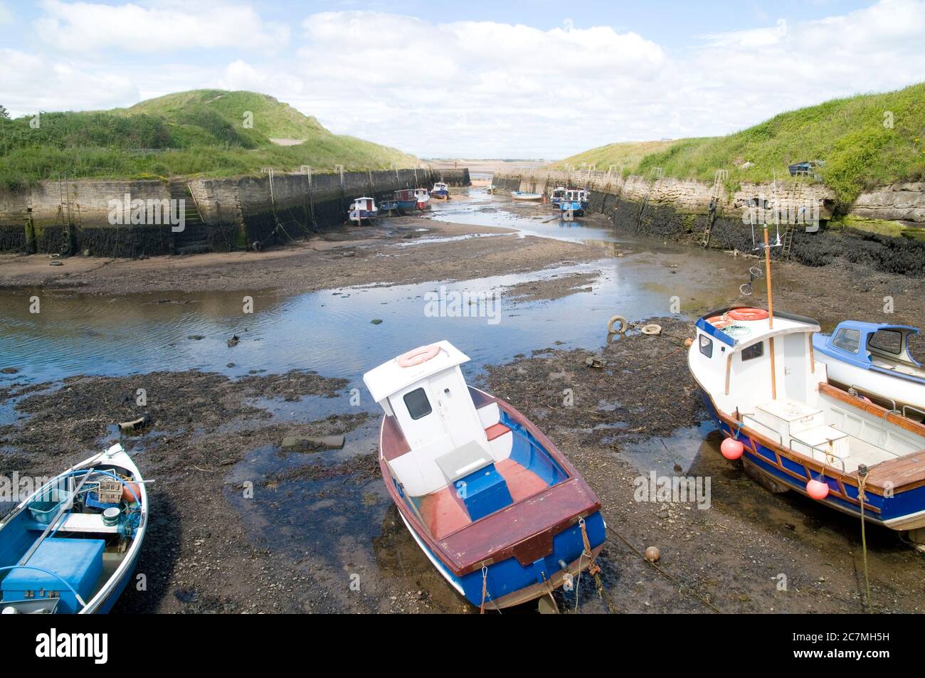 Boats at Seaton Sluice harbour at low tide Stock Photo Alamy