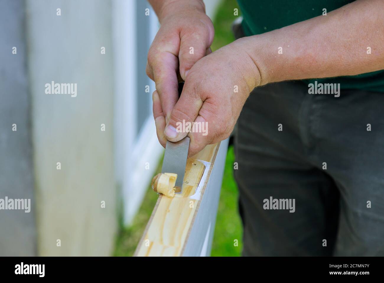 Wooden door installation of a hinge working with chisel prepared for