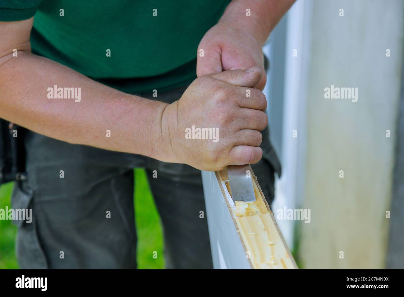 Carpenter working using a chisel a hinge wooden door a hinge is
