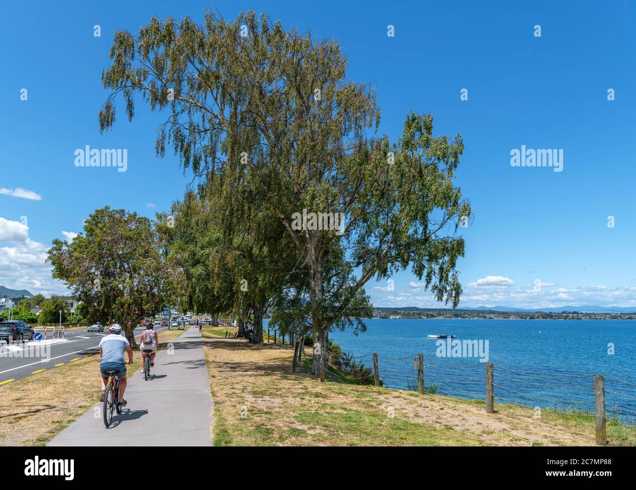Cyclists on a lakefront path in Taupo, Lake Taupo, New Zealand Stock Photo