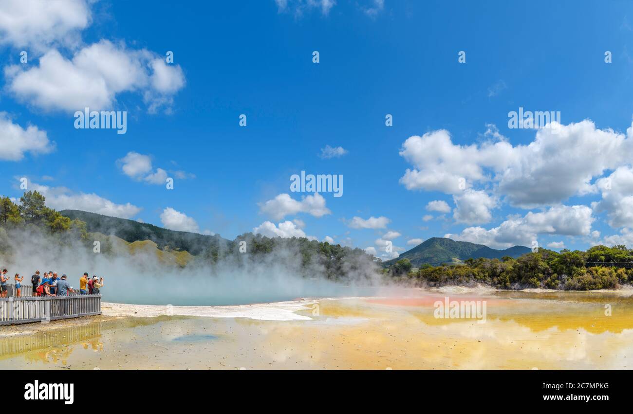 Visitors by the Champagne Pool hot spring at Wai-O-Tapu Thermal Wonderland, near Rotorua, New Zealand Stock Photo