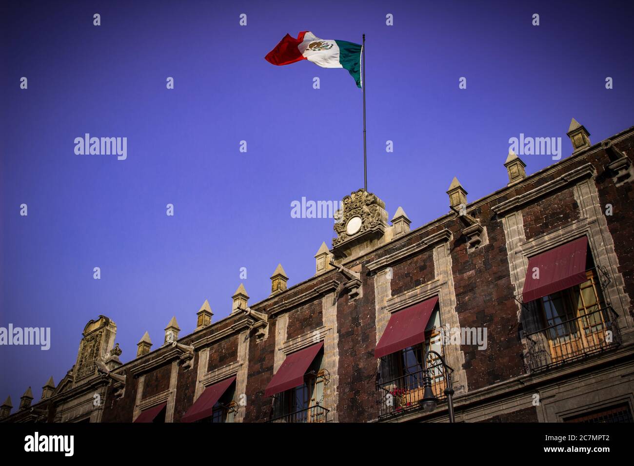 Low angle shot of the Mexican flag in Mexico City Downtown Stock Photo