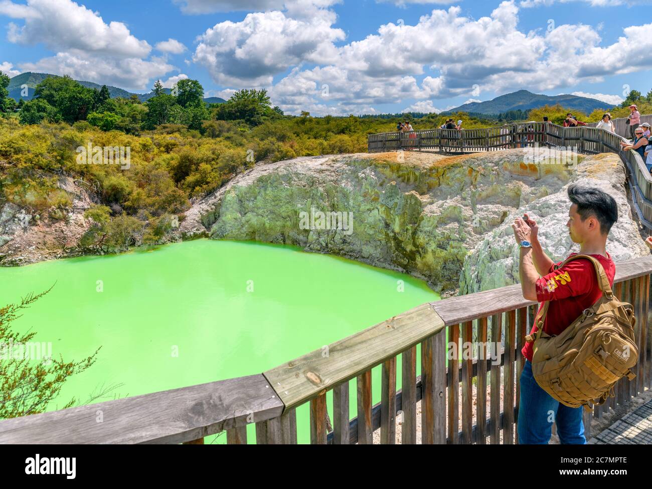 Visitors by the Devil's Bath sulphur pool at Wai-O-Tapu Thermal Wonderland, near Rotorua, New Zealand Stock Photo