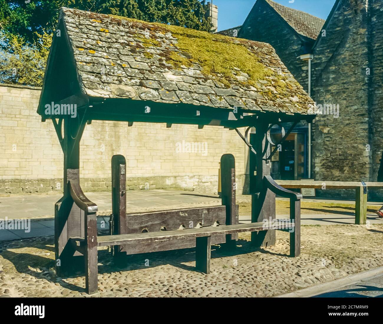 The image is of the preserved punishment stocks used to punish petty ...