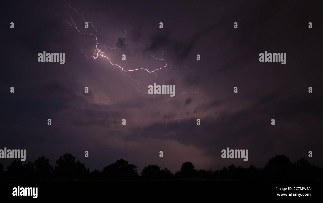 Lightning strikes through clouds at night over Kiel, Schleswig-Holstein, Germany Stock Photo