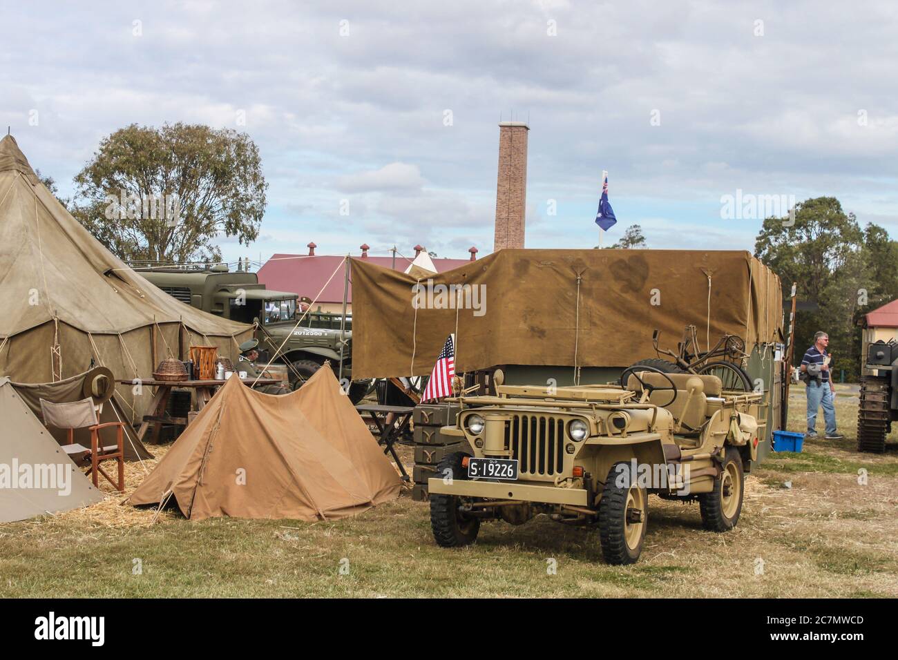 Brisbane Australia May 09 2014 Jeeps carrying bicycles and tents and flags in WW2 reenactment at Living History event Stock Photo