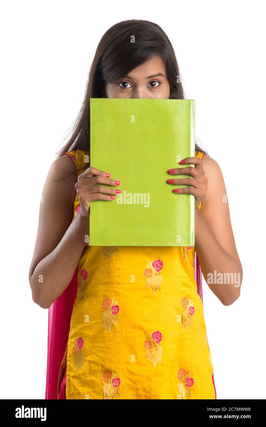 Pretty young girl holding book and posing on white background Stock ...