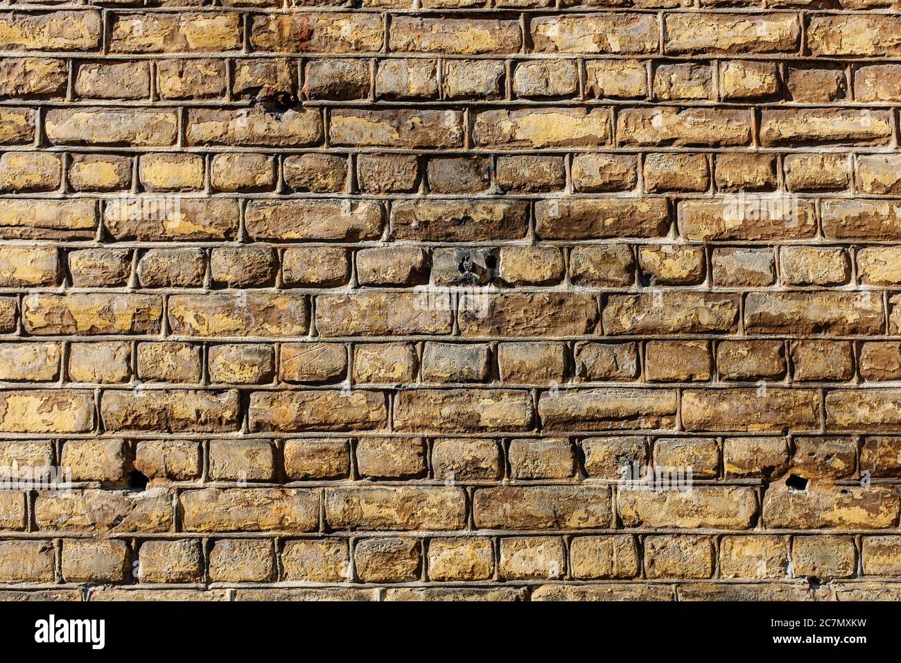Wall made out of brown rectangular stones Stock Photo